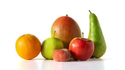 fresh fruit group - apple green and red, pear, mango and orange, lie on a white table, isolated