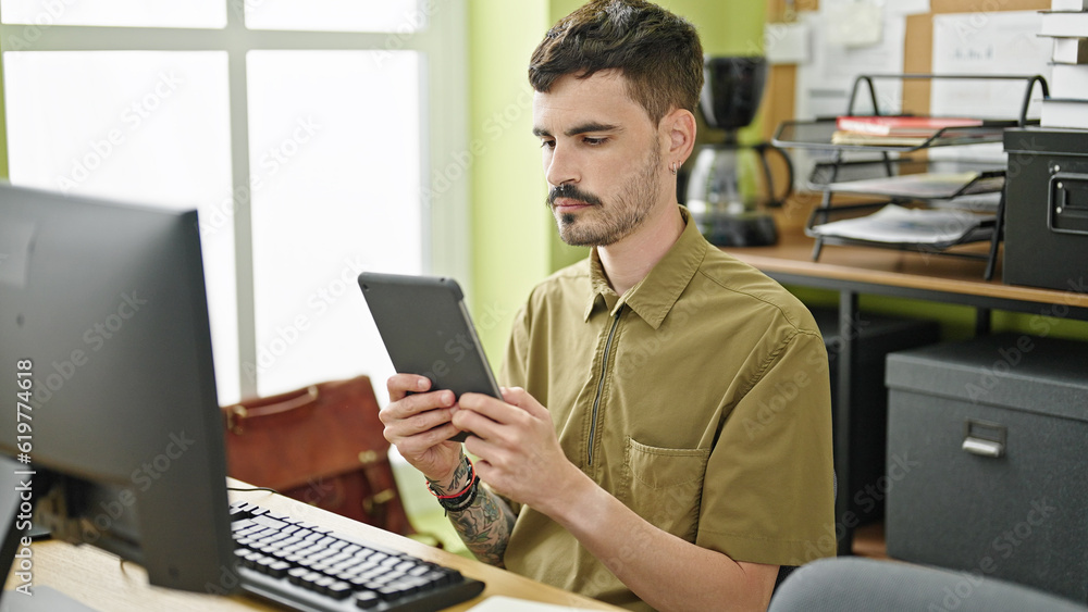 Canvas Prints Young hispanic man business worker using computer and touchpad working at office