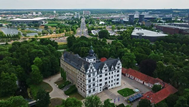 Drone shot of Wolfsburg Castle ( Schloss Wolfsburg ) . The Wolfsburg is a medieval lowland and water castle in North Germany .