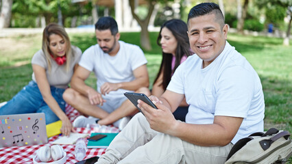 Group of people students using touchpad studying at park
