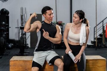 Fototapeta na wymiar Asian men and women Have a strong body, good health, love to exercise. They are exercising together at the gym having fun.