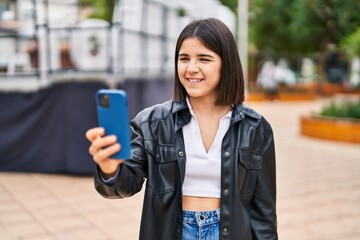 Young beautiful hispanic woman smiling confident making selfie by the smartphone at park