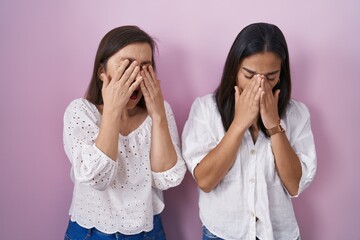 Hispanic mother and daughter together rubbing eyes for fatigue and headache, sleepy and tired...