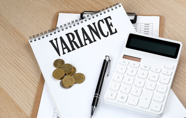 VARIANCE text on a notebook with chart and calculator and coins, business concept