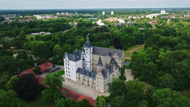 Drone shot of Wolfsburg Castle ( Schloss Wolfsburg ) . The Wolfsburg is a medieval lowland and water castle in North Germany .