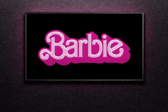 TV screen playing Barbie trailer or movie. TV on black textured wall. Astana, Kazakhstan - July 2, 2023.