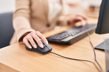 Young blonde woman business worker using keyboard and mouse at office