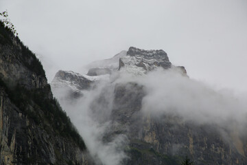 Large Mountain in Switzerland surrounded by clouds