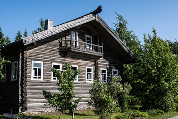 wooden house decorated with carvings and carved figures based on ancient motifs