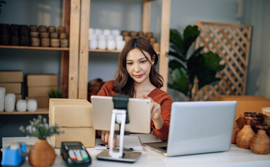 Fototapeta premium A Small business owner is live streaming to sell vases online. Manage e-commerce inventory, process orders, build trust with customers through reliable delivery to ensure a good shopping experience.