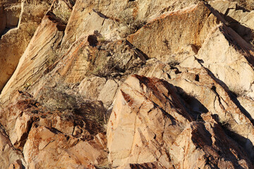 Layered rocks and hills. Surface of a natural stone brown colour