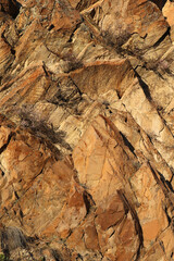 Layered rocks and hills. Surface of a natural stone brown colour