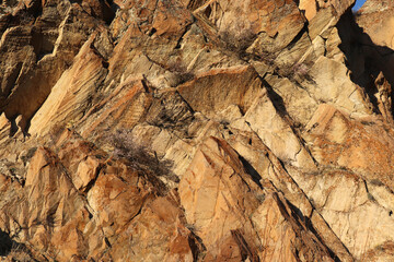 Layered rocks and hills. Surface of a natural stone brown colour