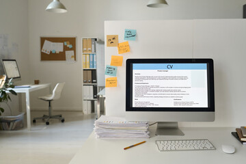 Workplace of business person with computer with online resume on monitor in modern office