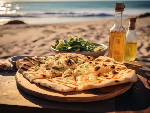 A Garlic Flatbread On A Table On The Beach