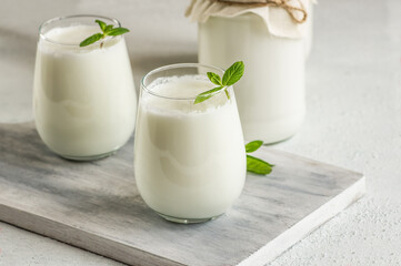Glass cup of Turkish traditional drink ayran , kefir or buttermilk made from yogurt, healthy food