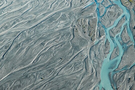 An aerial view of Glacier water from Mount Cook flowing through the Waiho River in Franz Josef, Southland, New Zealand. 