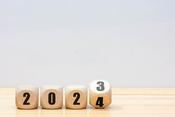 Wooden 2023 to 2024 new year white background. 
Word 2023 - 2024 wood cube on wooden desk for copy space.  - Powered by Adobe