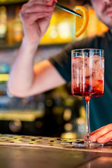 Fototapeta na wymiar man hand bartender making cocktail in glass on the bar counter