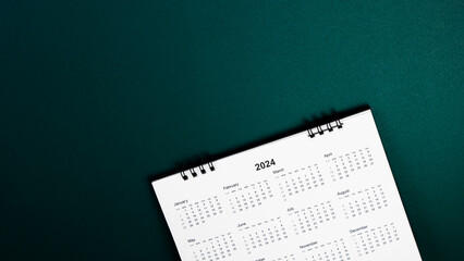 Fototapeta na wymiar Calendar year 2024 schedule on green dark background. 2024 calendar planning appointment meeting concept. copy space. top view.