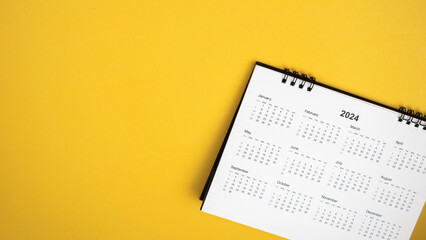Calendar year 2024 schedule on yellow background.
2024 calendar planning appointment meeting concept. 
copy space.
top view.
 - obrazy, fototapety, plakaty
