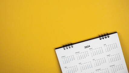 Calendar year 2024 schedule on yellow background.
2024 calendar planning appointment meeting concept. 
copy space.
top view.
 - obrazy, fototapety, plakaty