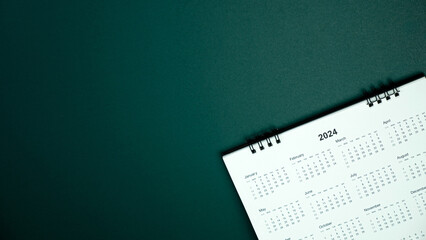 Calendar year 2024 schedule on green dark background.
2024 calendar planning appointment meeting concept. 
copy space.
top view. - obrazy, fototapety, plakaty