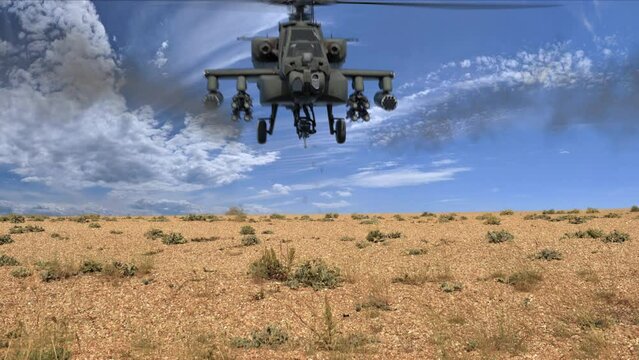 Attack helicopter fires machine gun and rockets at camera in the desert, good use for Middle Eastern War e.g. Afghanistan. Helicopter fires missiles 