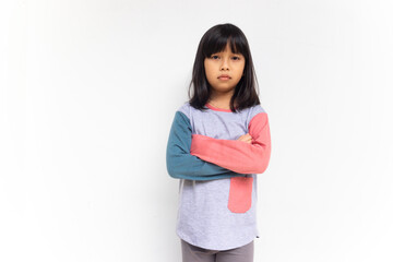 A girl with serious face looking at camera while crossing his hands. Unhappy feeling concept