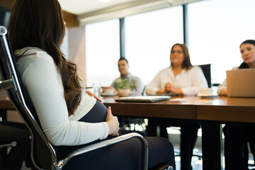 Fototapeta premium Pregnant woman giving job interview at office