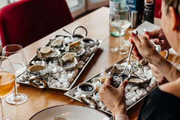 Fresh oysters with lemon. raw opened oyster, lifestyle food, ready to eat. Oyster dinner with champagne in restaurant © Надія Коваль
