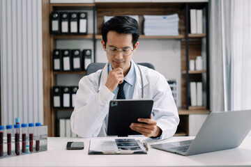 Fototapeta premium Medical Technology Concepts. The doctor is working on a tablet digital tablet computer in office in the morning at the desk.