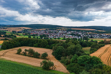 Fototapeta na wymiar Bird's-eye view of Wörsdorf/Germany in the Taunus just before a thunderstorm