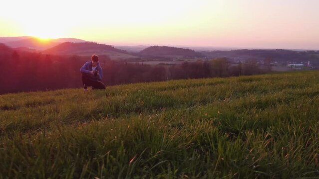 Amateur photographer sets up and shoots his models during the golden hour in a natural magical scenery. 4k video