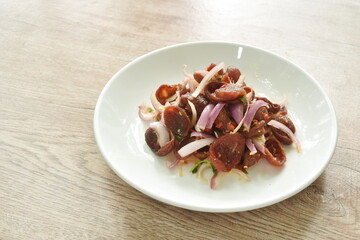 spicy and sour Chinese pork sauce with shallot salad on plate 