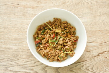 spicy stir fried chop pork with chili and basil leaf on bowl
