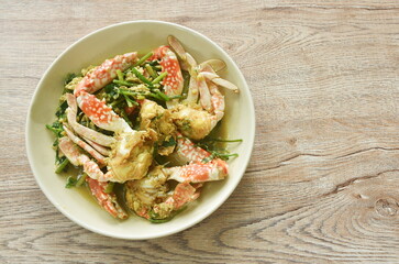 stir fried swimmer crab in yellow curry and egg on plate