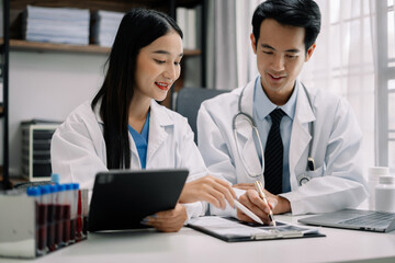Doctors working together on digital tablet healthcare doctor technology tablet using computer in a modern office.