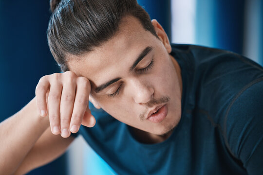 Exercise, Sweat And A Tired Sports Man Breathing In The Gym After An Intense Or Physical Workout For Health. Fitness, Fatigue And A Young Male Athlete Or Runner Finished With His Cardio Training