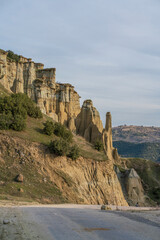 Fairy chimneys rock forms and sunset colors in the sky in Kula district of Manisa province