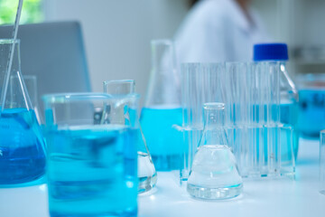Glassware, beaker or test tube with blue substance or liquid. Concept of laboratory  background. Scientific analysis tools background. Chemistry and experiment glassware.