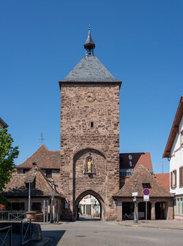 Molsheim, France - 06 24 2023: City of Molsheim. View of the entrance door on the Blacksmiths Gate with a statue of Mary.