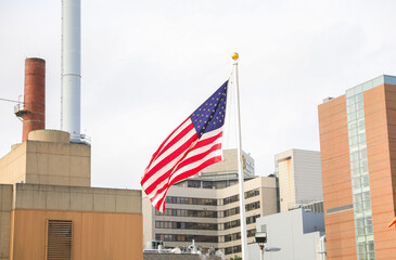 US flag waves proudly on July 4th, symbolizing patriotism and honoring fallen heroes. Amidst economic challenges, it represents resilience and unity
