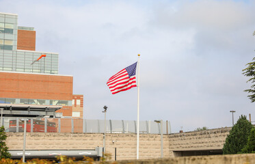 US flag waves proudly on July 4th, symbolizing patriotism and honoring fallen heroes. Amidst economic challenges, it represents resilience and unity