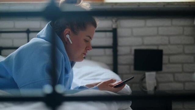 Woman reads e-book in her bed, 4k