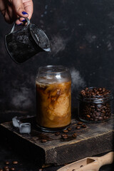 Cold coffee in a glass on a dark background