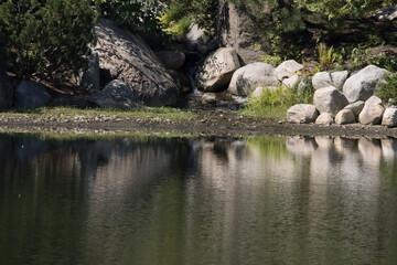 Naklejka na ściany i meble Rocks reflected in a lake