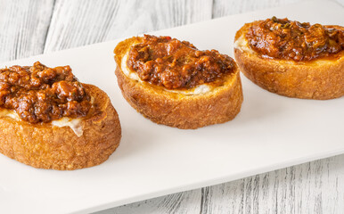 Ciabatta bruschettas with mozzarella and puttanesca