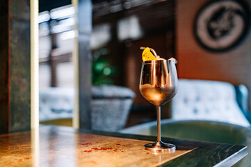 alcohol cocktail in a glass stands on a table in a bar or restaurant