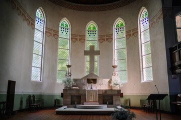 The interior of the church is adorned with beautiful stained glass windows, ornate wooden pews, and...